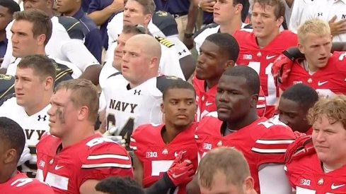 Ohio State and Navy football players gather for the schools' alma maters following the game.