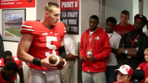 Jeff Heuerman hands the Cincinnati game ball to the Studebaker brothers