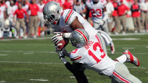 Raekwon McMillan steals a pass from both Maryland and teammate Eli Apple.