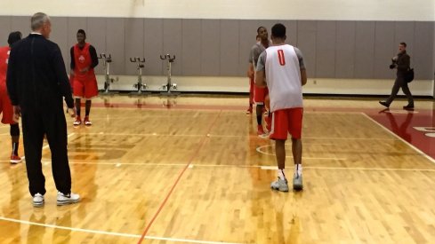 Thad Matta looks on.