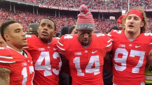 Jalin Marshall, Darron Lee, Curtis Grant and Joey Bosa celebrate Ohio State's 42–28 win over Michigan.