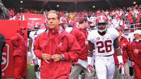 Alabama coach Nick Saban walks out on to the field with safety Landon Collins