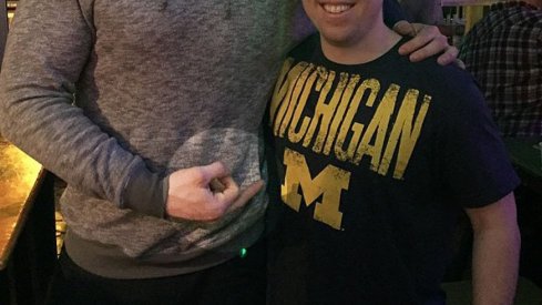 Former Ohio State tight end poses – full bird – with a man wearing a Michigan t-shirt.