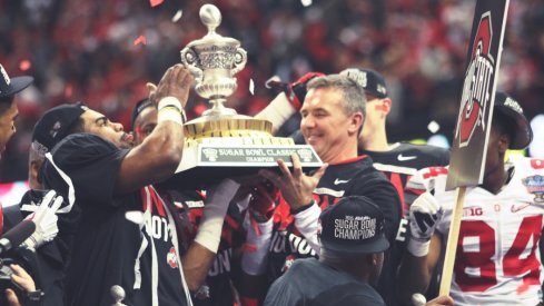 Sugar Bowl offensive MVP Ezekiel Elliott and head coach Urban Meyer hoist the Sugar Bowl hardware.