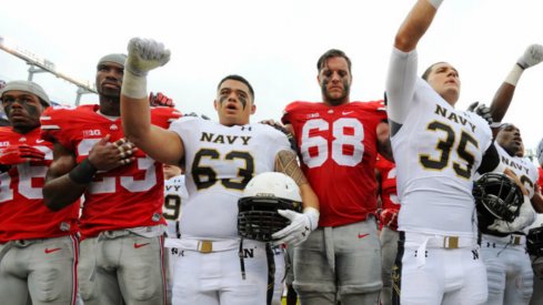 Ohio State and Navy players sing after the game. 