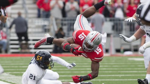 Ezekiel Elliott leaps over a Kent State defender. 