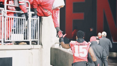 Ezekiel Elliott high-fives a fan at Ohio Stadium.