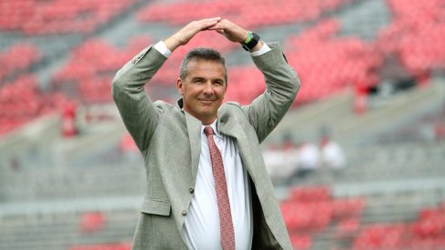 Urban Meyer hits the 'O' during his entrance to Ohio Stadium.