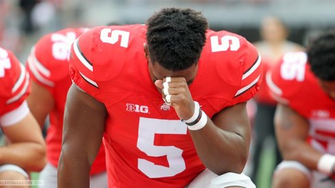 Raekwon McMillan takes a moment before the game.