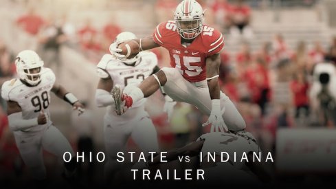 Ezekiel Elliott hurdles a defender.