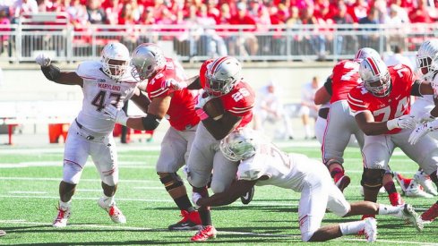 Bri'onte Dunn dragging a Terrapins defender with him.