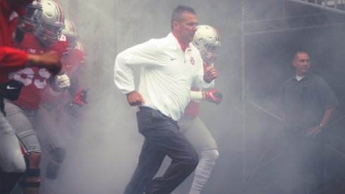 Urban Meyer takes the field. 