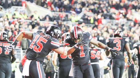 Ezekiel Elliott and Braxton Miller dab on Joe Pa's grave.