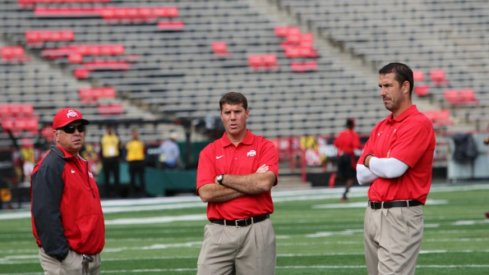 Tim Hinton, Chris Ash and Luke Fickell gathered on the field. 