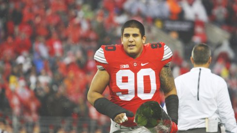 Tommy Schutt runs onto the field on Senior Day.