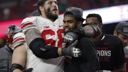 Taylor Decker hugs Ezekiel Elliott after Ohio State's Fiesta Bowl win.