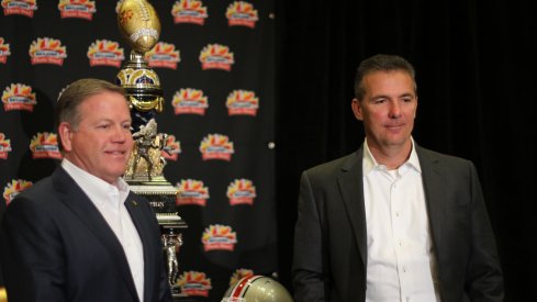 Brian Kelly, Urban Meyer pose with Fiesta Bowl trophy.