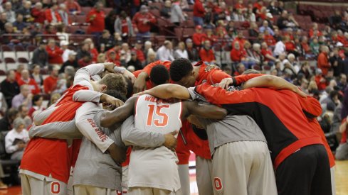 The Buckeyes huddle up before the tip against their rivals.