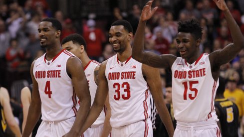 Daniel Giddens, Keita Bates-Diop and Kam Williams celebrate win over Iowa.