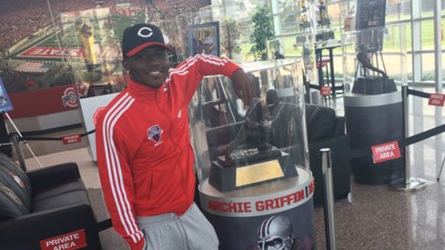 Five-star wide receiver Tyjon Lindsey poses with Archie Griffin's Heisman Trophy at the Woody Hayes Athletic Center