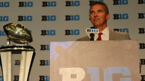 Urban Meyer and the B1G championship trophy.