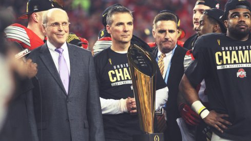 Urban Meyer and the CFP trophy.