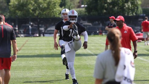 J.T. Barrett goes through warmups on Day 1 of fall camp. 