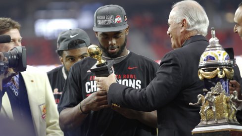 J.T. Barrett accepts his Fiesta Bowl MVP trophy.