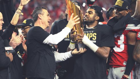 Urban Meyer, Ezekiel Elliott hold up the CFP trophy in 2014.