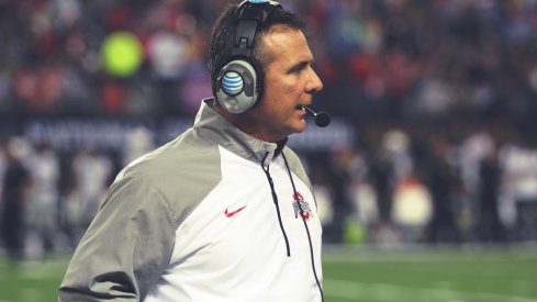 Urban Meyer strolls the sidelines.