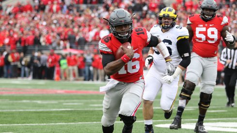 J.T. Barrett carries the ball against Michigan. 