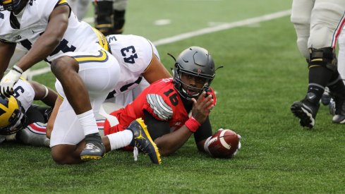 J.T. Barrett reaches for a first down vs. Michigan. 