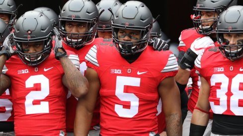 Dontre Wilson and Raekwon McMillan lead Ohio State onto the field. 