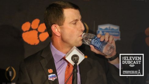 Dabo Swinney takes a drink of water in a press conference before the Fiesta Bowl.