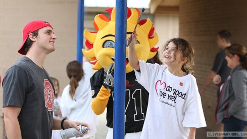 Drue Chrisman helps paint a pole at Alta E. Butler Elementary School in Phoenix