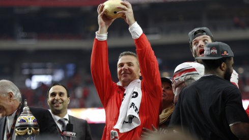 Urban Meyer lifts the 2016 Battlefrog Fiesta Bowl trophy.