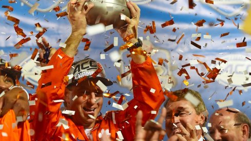 Clemson coach Dabo Swinney celebrates with the 2016 ACC championship trophy.