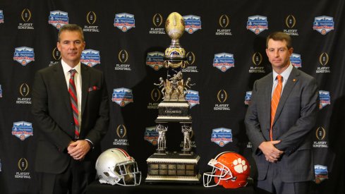 Urban Meyer and Dabo Swinney pose with the Fiesta Bowl trophy. 