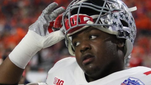 Jamarco Jones takes off his helmet after Ohio State's loss to Clemson in the Fiesta Bowl.