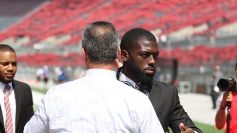 J.T. Barrett meets with Urban Meyer prior to a game last season.