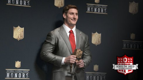Joey Bosa poses with his NFL Defensive Rookie of the Year trophy.