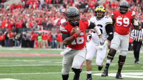 Ohio State quarterback J.T. Barrett scores against Michigan.