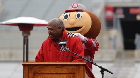 Brutus Buckeye rubs Gene Smith's shoulders.