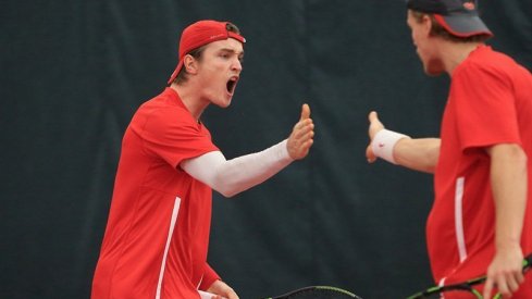 Mikael Torpegaard and Herkko Pollanen celebrate after a doubles win.