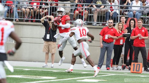 Johnnie Dixon hauls in a pass over Kendall Sheffield. 