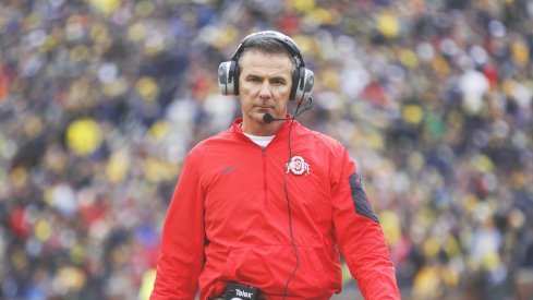 Urban Meyer strolls the sidelines at Michigan. 