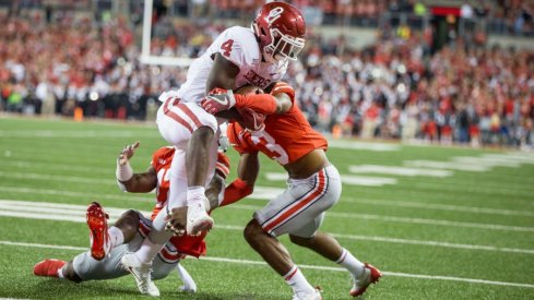 damon arnette attempts to tackle trey sermon as he scores