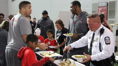Matthew Burrell (left) and Thayer Munford (right) were among the Ohio State football players who participated in Wednesday morning's event at the Woody Hayes Athletic Center.