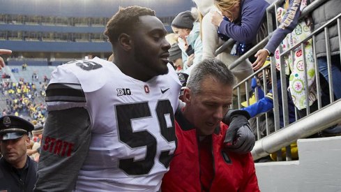 Tyquan Lewis and Urban Meyer exit the field following Ohio State's 31-20 win over Michigan