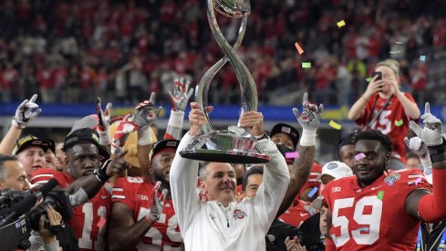 Dec 29, 2017; Arlington, TX, USA; Ohio State Buckeyes coach Urban Meyer holds the championship trophy after the 2017 Cotton Bowl against the Southern California Trojans at AT&T Stadium. Ohio State defeated USC 24-7. Mandatory Credit: Kirby Lee-USA TODAY Sports